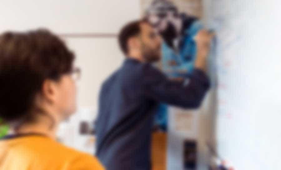 man writing on the whiteboard